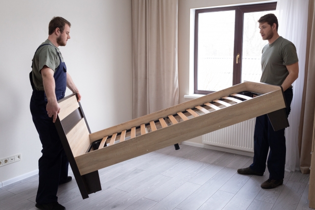 ベッドを組み立てる男性