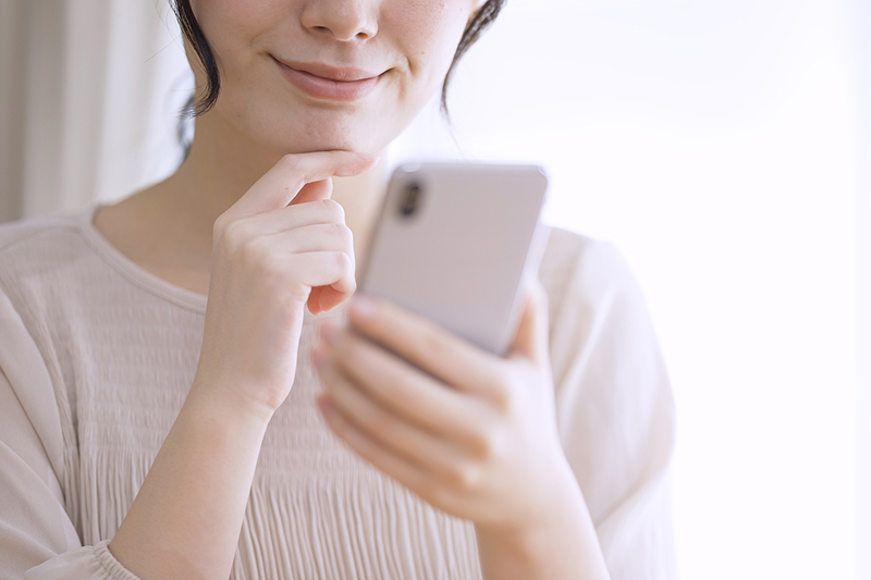 スマホを見て考えているイメージ